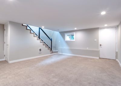 Spacious renovated basement with a modern and open layout. The neutral color scheme and new finishes create a welcoming atmosphere, perfect for entertaining or relaxing with family