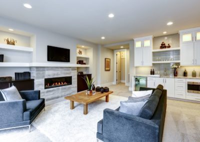 Beautifully renovated basement with new carpet, fresh paint, custom made kitchen and modern fireplace