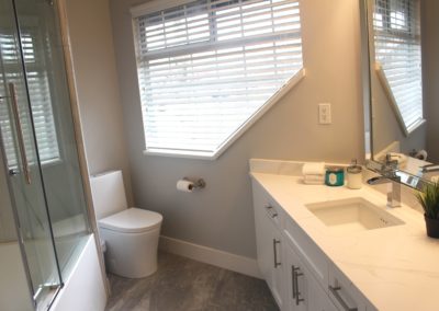 Freshly renovated white bathroom with clean lines and a spa-like atmosphere