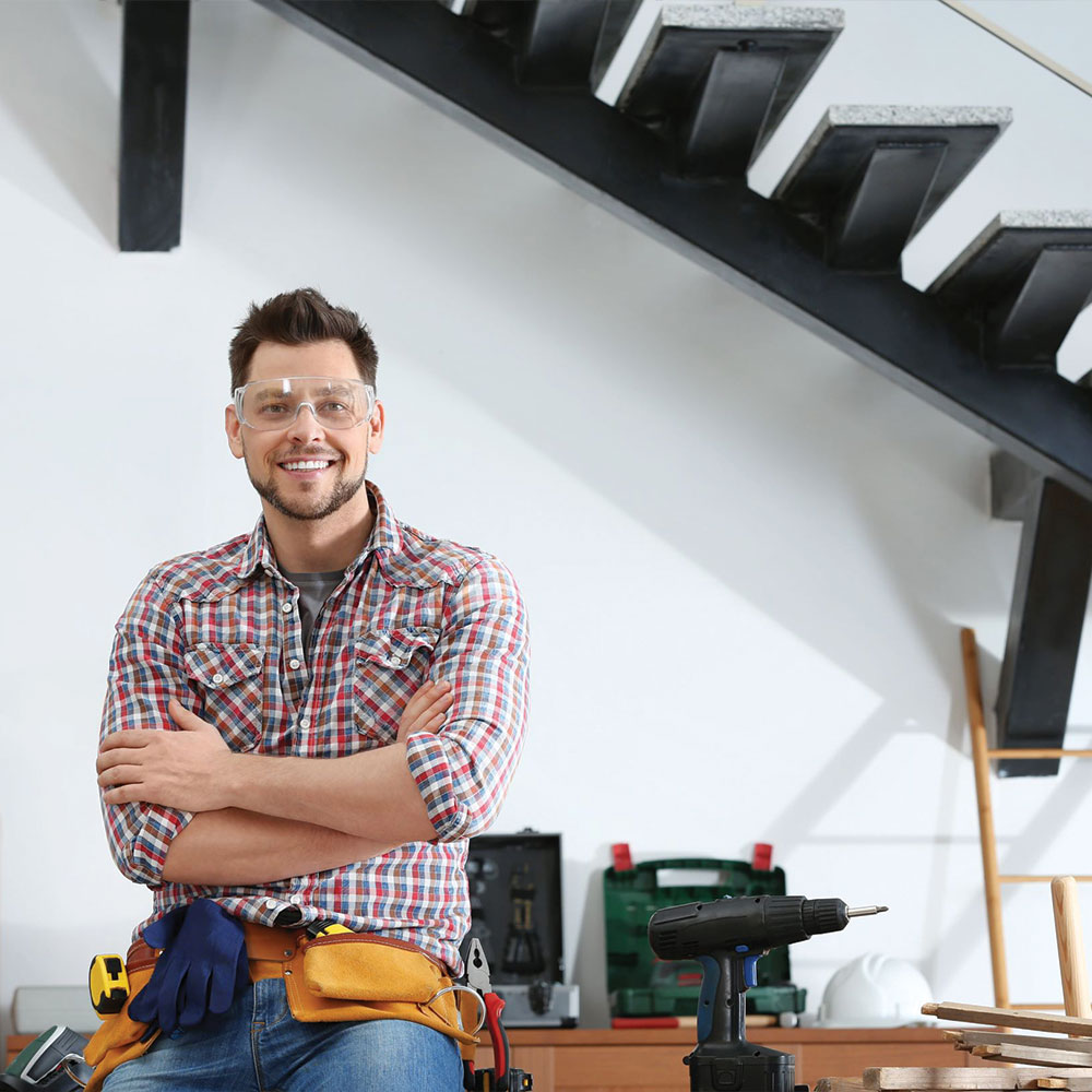 a construction worker stops to pose as he works on the latest project