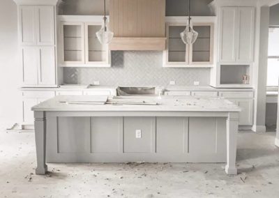 Kitchen undergoing renovation with new cabinets and countertops being installed. The open concept design and natural light create a spacious and inviting atmosphere once the renovation is complete. Perfect for entertaining or relaxing with family