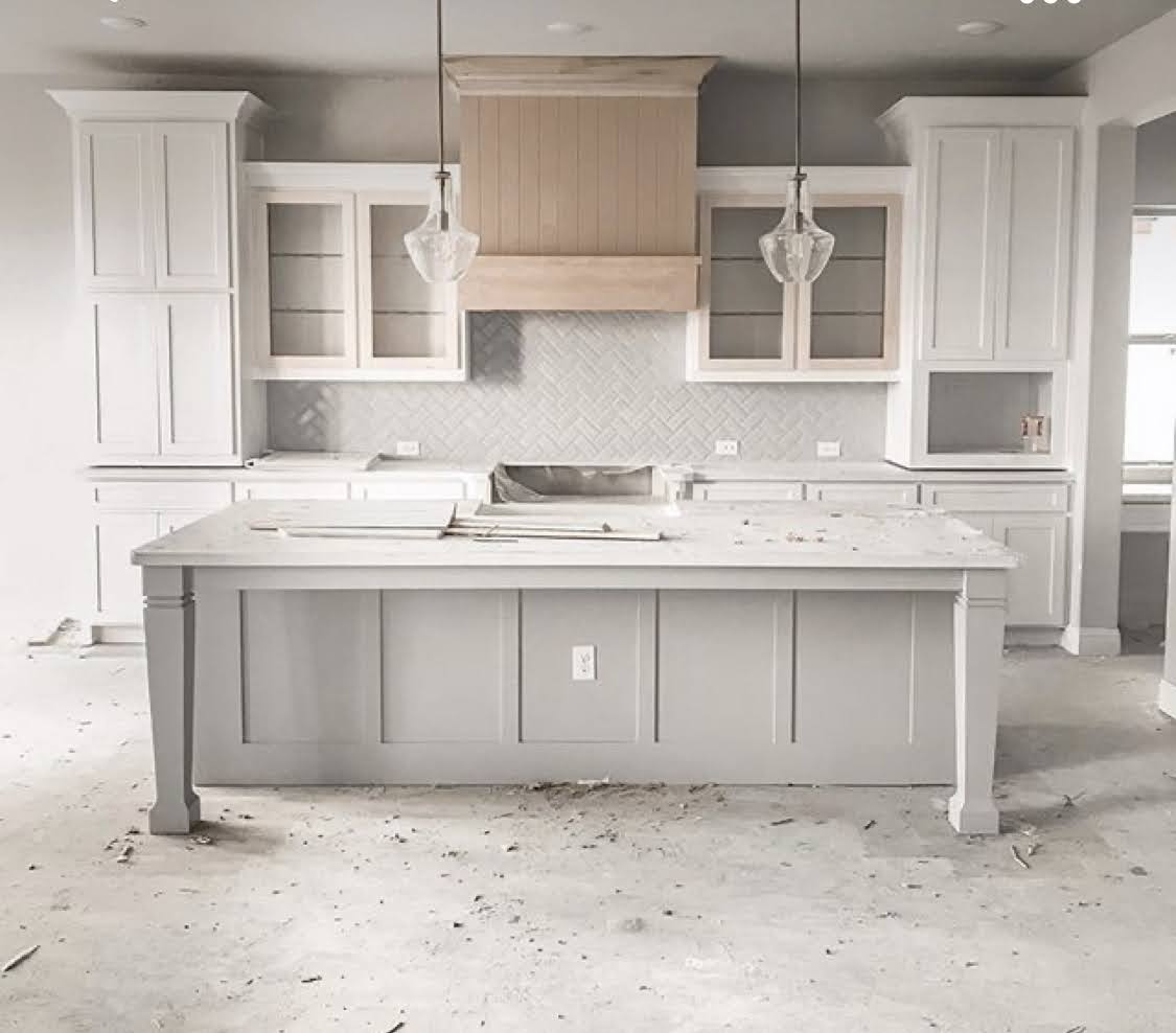Kitchen undergoing renovation with new cabinets and countertops being installed. The open concept design and natural light create a spacious and inviting atmosphere once the renovation is complete. Perfect for entertaining or relaxing with family