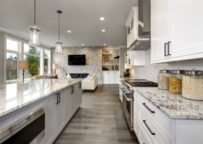 Full house renovation with kitchen shaker panels and quartz countertops. Accent wall and modern fireplace. New flooring, fresh paint and stylish appliances