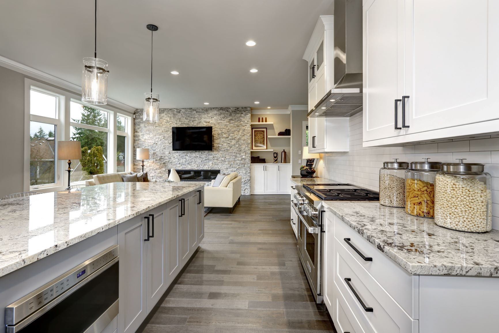 Full house renovation with kitchen shaker panels and quartz countertops. Accent wall and modern fireplace. New flooring, fresh paint and stylish appliances