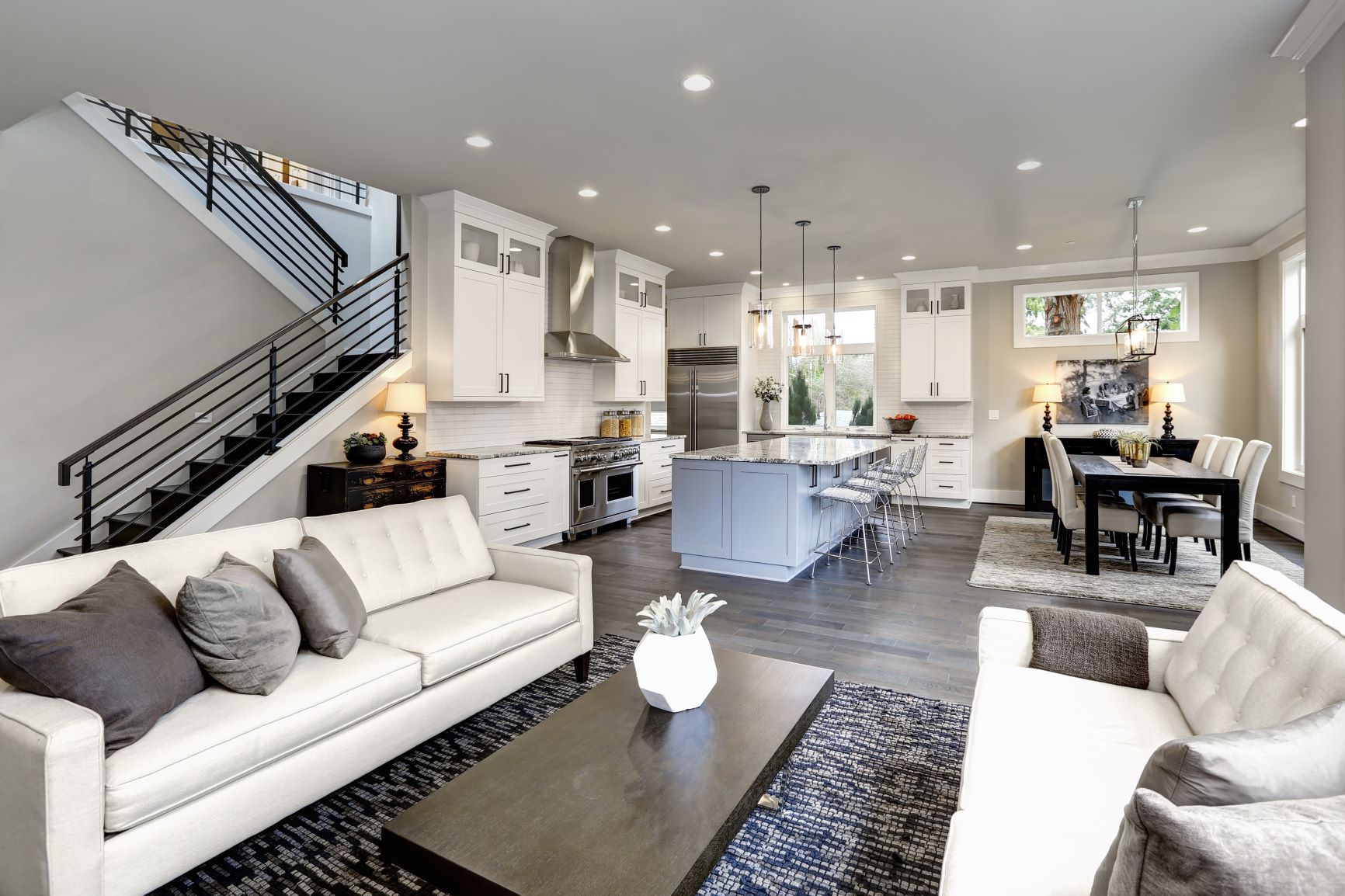 White custom-made kitchen shaker panels. Quartz countertop. New laminate flooring. Fresh paint.