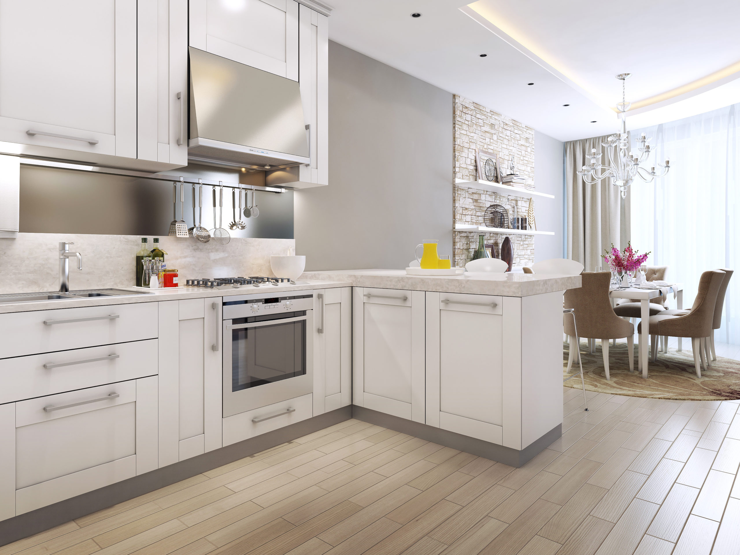 Bright and modern renovated kitchen in a condo with white cabinets and sleek finishes. The kitchen features a large center island with seating, perfect for entertaining