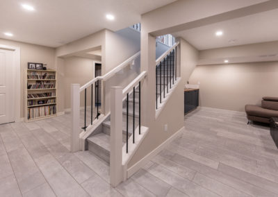 Renovated basement with new staircase, fresh paint and new flooring