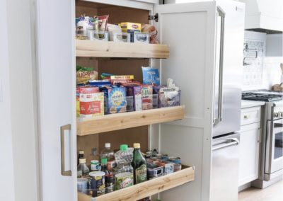Functional pantry in a renovated kitchen with plenty of storage and organization options. The pantry features shelving, baskets, and bins to keep ingredients and supplies neatly stored and easy to access. The pantry is a convenient addition to the kitchen, providing additional storage space and helping to keep the main cooking area clutter-free
