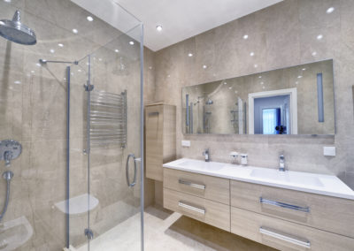 Renovated bathroom with light paige tiles and custom double vanity - fresh and inviting design