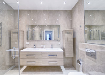 Renovated bathroom with light paige tiles and custom double vanity - fresh and inviting design