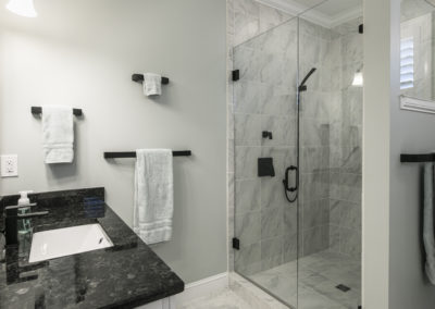 Renovated shower with black fixtures and grey tiles - chic and modern design