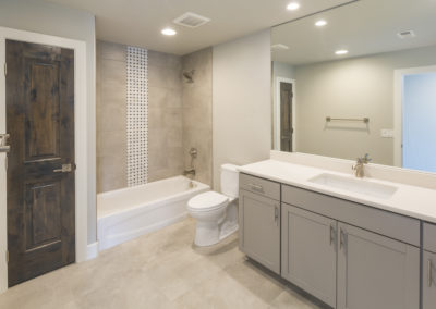 Renovated bathroom with custom made paige vanity and tub - stylish and luxurious design