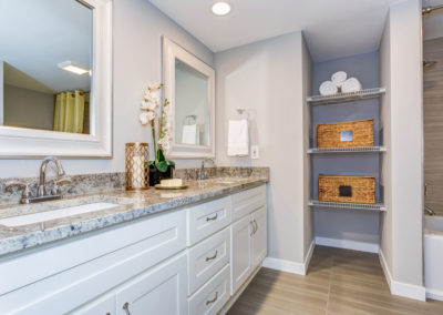 Elegant bathroom with custom-made double white vanity cabinet and built-in storage