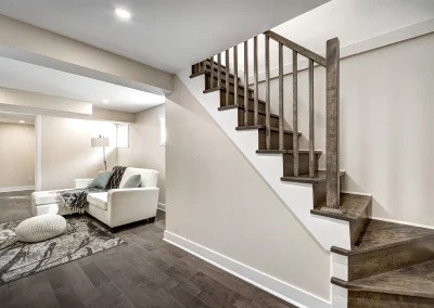 Custom Desgin stairs leading to the basement. New flooring, fresh paint ceiling pot lights