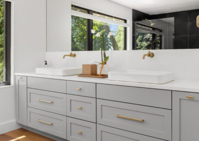 custom made grey double vanity with gold fixture and free standing tub. Sophisticated and luxury look