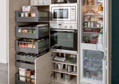 Functional pantry in a renovated kitchen with plenty of storage and organization options. The pantry features shelving, baskets, and bins to keep ingredients and supplies neatly stored and easy to access. The pantry is a convenient addition to the kitchen, providing additional storage space and helping to keep the main cooking area clutter-free